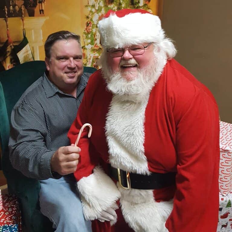 Brian holding a candy cane with Santa